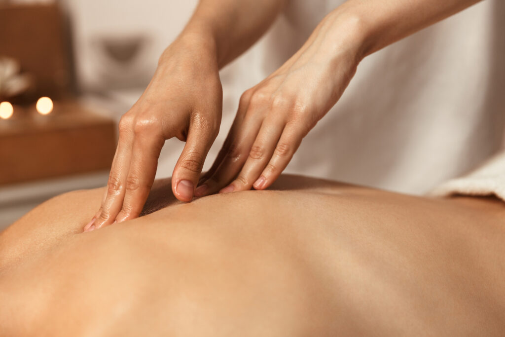 Woman relaxing in a spa and having a massage